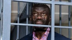 Veteran Ugandan opposition leader collapses in court and in ICU, his wife says