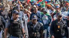 Special police team to investigate killing of an anti-migrant leader in South Africa