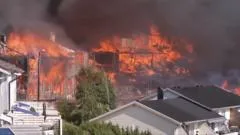 Helicopters dump water as huge Norway fire destroys homes